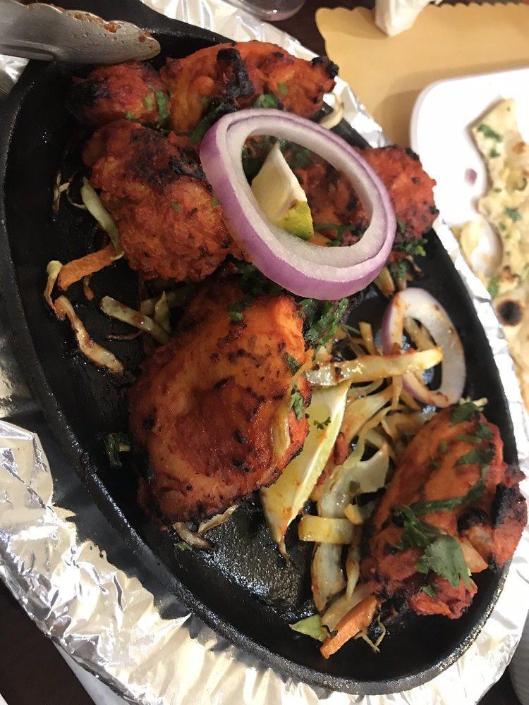 Tandoori Chicken · Tender bone in chicken, marinated with exotic tandoori spices, roasted in clay oven, served with mint chutney and onion salad.