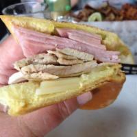 Media Noche Sandwich · Sliced pork, ham, Swiss cheese, mustard and pickles on sweet bread.