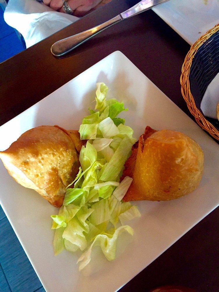 Vegetable Samosa · Delicately spiced potatoes & pes wrapped in crispy pastry. 