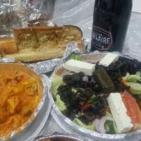 Greek Salad · Lettuce, tomato, onions, cucumber, carrots, olives, stuffed grape leaves and feta cheese.