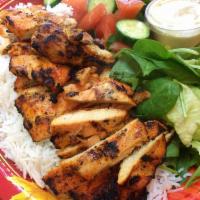 Grilled Chicken Breast Plate · Includes rice, mixed green salad, corn, cucumber and tomato, pita bread with garlic sauce. 