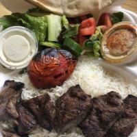 Beef Kabob Plate · Includes rice, mixed green salad, corn, cucumber and tomato, pita bread with garlic sauce. 
