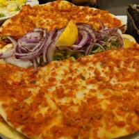 Lahmacun · Round, thin pieces of dough topped with minced lamb and beef.