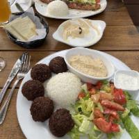 Falafel Plate · Ground chickpeas balls served with rice, hummus, salad and tahini sauce.