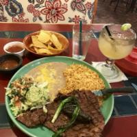 Carne Asada · Slices of skirt cooked over charcoal. Served with guacamole, broiled green onions, jalapenos...