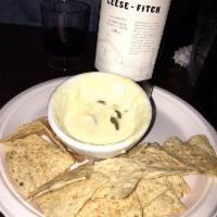 Queso · Homemade cheese dip made with pickled jalapenos. Served with tortilla chips. Gluten-free.