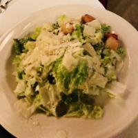 Classic Caesar Salad · Romaine hearts, shaved Romano, garlic croutons, anchovies and traditional dressing.