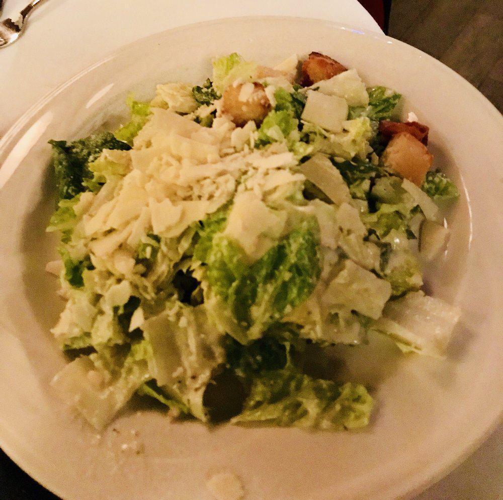 Classic Caesar Salad · Romaine hearts, shaved Romano, garlic croutons, anchovies and traditional dressing.