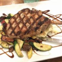 Pork Chop · 12 oz. chop served with Baked Sweet Potato loaded with butter and brown sugar, sauteed Veget...