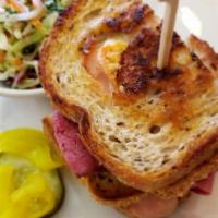 Reuben · Tender corned beef topped with Swiss, sauerkraut and 1000 island on grilled rye.  Substitute...