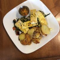Tofu Scramble · Turmeric tofu with spinach, bell pepper, zucchini, onion, and potatoes served with salsa. Ve...