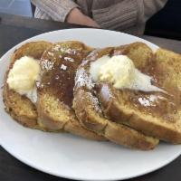 French Toast · 4 pieces of custard battered french toast, topped with butter, a dusting of powdered sugar a...