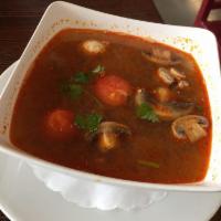 Tom Yum Koong Soup · Spicy and sour lemongrass soup with shrimp, mushroom, scallion and cilantro. 1/5 Spicy.
