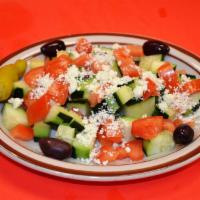 Greek Salad · Cucumber, tomato, onions, bell pepper topped with feta cheese served with dressing and speci...