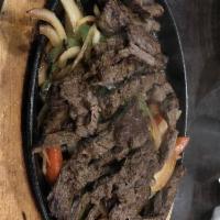 Fajitas · Fajita-seasoned with sliced bell peppers and onions. Served up sizzling in a hot cast-iron f...