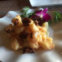 Walnut Shrimp · Lightly coated crispy shrimp tossed in a flavorful pineapple cream sauce and topped with car...