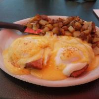 Eggs Benedict · Two basted eggs, smoked ham on English Muffin, topped with Hollandaise sauce