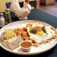 Chilaquiles · Corn tortilla chips simmered in your choice of salsa (verde or roja) topped with melted chee...
