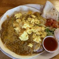 Huevos Rancheros · A flour tortilla layered with beans, green or red chili and cheese topped with 2 eggs, lettu...