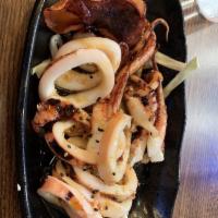 Grilled Whole Squid · Whole squid sliced and generously sauced.