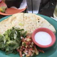 Quesadillas · Melted cheese inside flour tortillas and served with sides of pico de Gallo and crema. Add p...