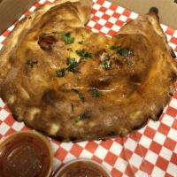 Calzone · A folded pizza with mozzarella and ricotta, marinara served on the side; add additional pizz...
