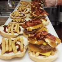 Big Boy Burger · Burger, bacon, American cheese, fries, mozzarella sticks, onion rings and BBQ sauce.