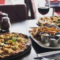 Loaded Mashed Potato Pizza · Garlic mashed potato, scallion, bacon, caramelized onion, mozzarella and cheddar cheese.