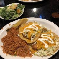 Fish Tacos · 2 deep fried cod fish tacos with cabbage, tomato, sour cream, and cheddar cheese. Served wit...