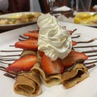 Nutella Crepes · Thin crepes filled with Nutella. Topped with fresh strawberries and whipped cream.