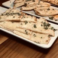 Crazy Pita Plate · Baked pita topped with garlic sauce and Parmesan cheese.