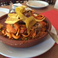 Paella · Cuban-style yellow rice casserole with assorted seafood: clams, mussels, shrimp, tilapia, an...