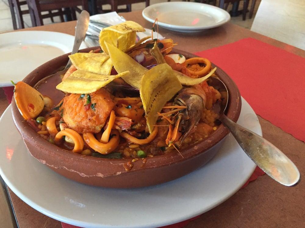 Paella · Cuban-style yellow rice casserole with assorted seafood: clams, mussels, shrimp, tilapia, and scallops.
Accompanied with a side of sweet plantains.