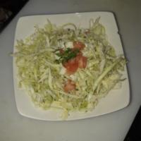 Cabbage Salad · Chopped cabbage, tomatoes, topped with dried mint, lemon juice and olive oil.