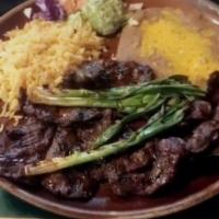 Carne Asada · Fillets of thinly sliced skirt steak charbroiled to perfection. Served with whole green onio...