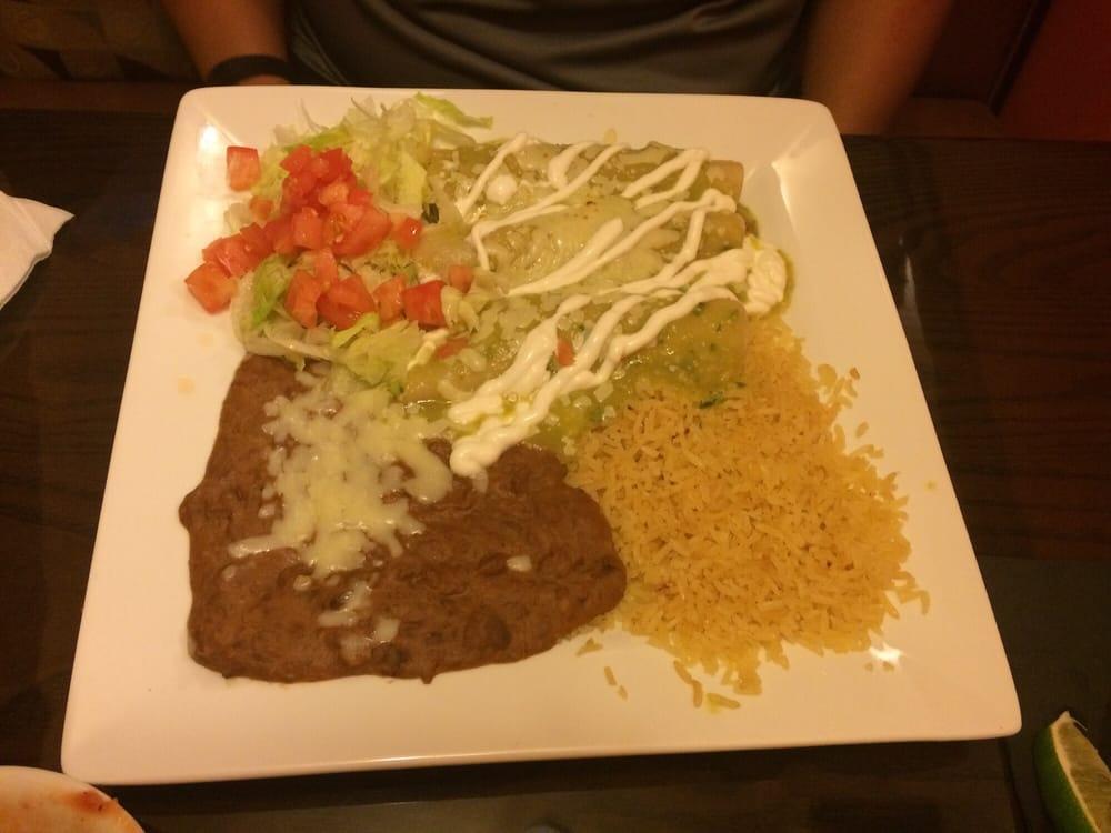 Enchiladas Verdes · 3 shredded beef enchiladas topped with green sauce, lettuce, sour cream and tomatoes. Served with rice and beans.
