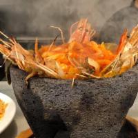 Molcajete · A traditional hot volcanic stone bowl filled with a juicy rib-eye steak, grilled chicken bre...