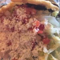 Gordita · Yellow corn masa cake filled with your choice of protein, refried or black beans, lettuce, t...