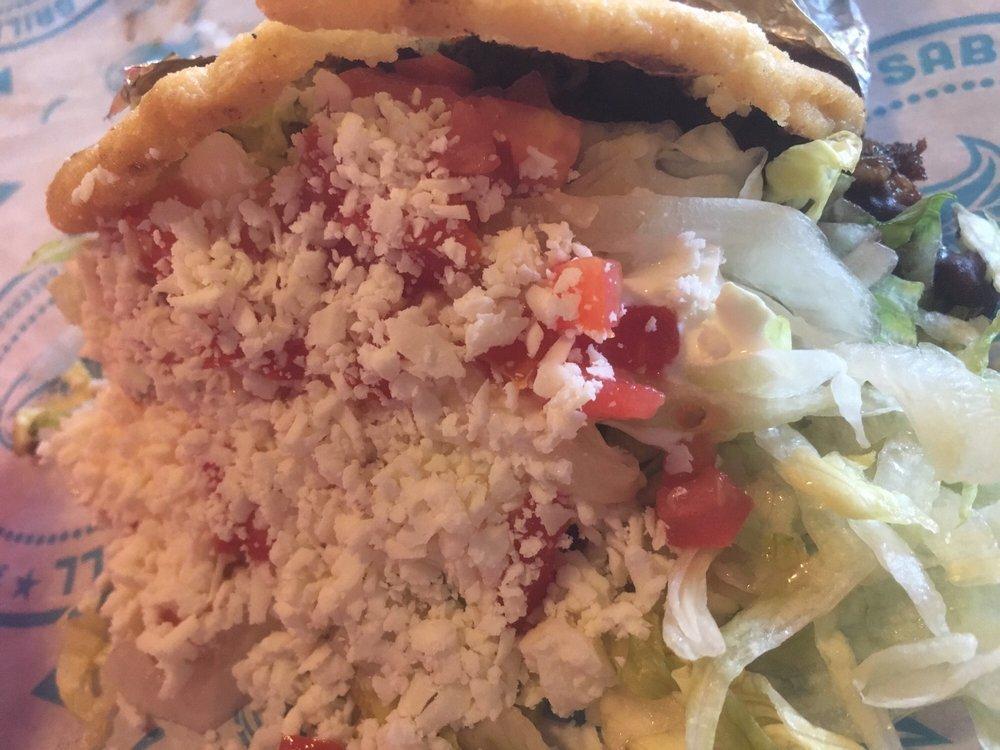 Gordita · Yellow corn masa cake filled with your choice of protein, refried or black beans, lettuce, tomato, sour cream and cheese.