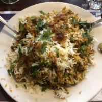 Chicken Biryani · Aromatic basmati rice cooked with special spices and garnished with cashew nuts and golden r...