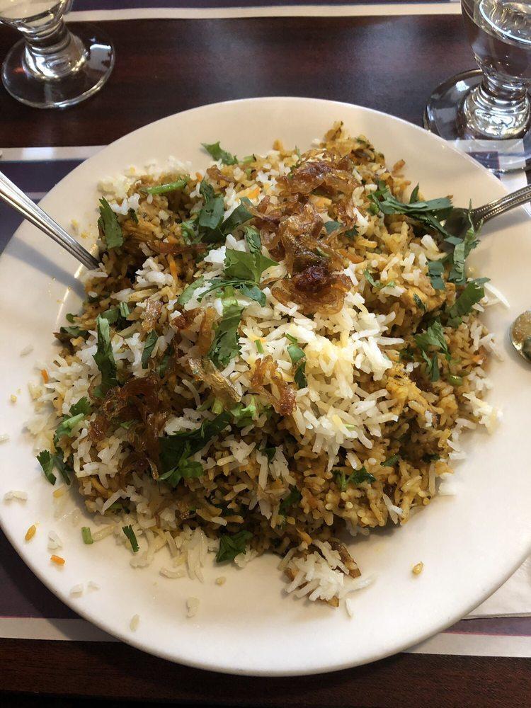 Chicken Biryani · Aromatic basmati rice cooked with special spices and garnished with cashew nuts and golden raisins.
