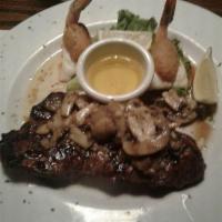 Surf and Turf · 10 oz. Grilled sirloin, finished with a mushroom, garlic butter. Served with 2 baked stuffed...