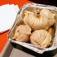 Soup Dumplings · Chicken soup inside pork dumplings. Choice of 6 or 10 dumplings.