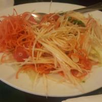 Papaya Salad · Traditional Thai salad of julienne green papaya, roasted peanuts and tomatoes, tossed with s...