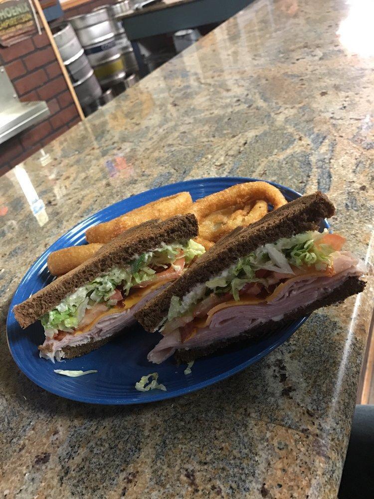 Smoked Turkey Club · Smoked turkey, crisp bacon and cheddar cheese with mayo lettuce and tomato. Served on lightly toasted squaw bread with vidalia onion dressing.