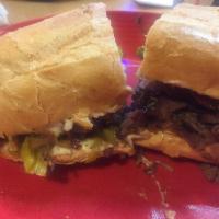 Philly Cheesesteak Sandwich · Grilled sliced steak with sauteed bell peppers, onions, pepperoncinis and provolone cheese. ...