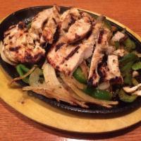 Chicken Fajitas · Grilled chicken and peppers over sauteed onions, served with pico de gallo, rice and flour t...