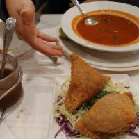 Samosas · Two crispy stuffed pastries seasoned with mild spices and deep fried. 