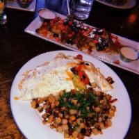 California Omelette · Three egg open-face omelette, crispy smoked bacon, tomato, avocado, sour cream, cheddar chee...