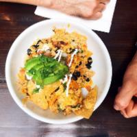 Chilaquiles · Corn tortilla chips, scrambled eggs, braised  pulled chicken, black beans, cheddar cheese, p...